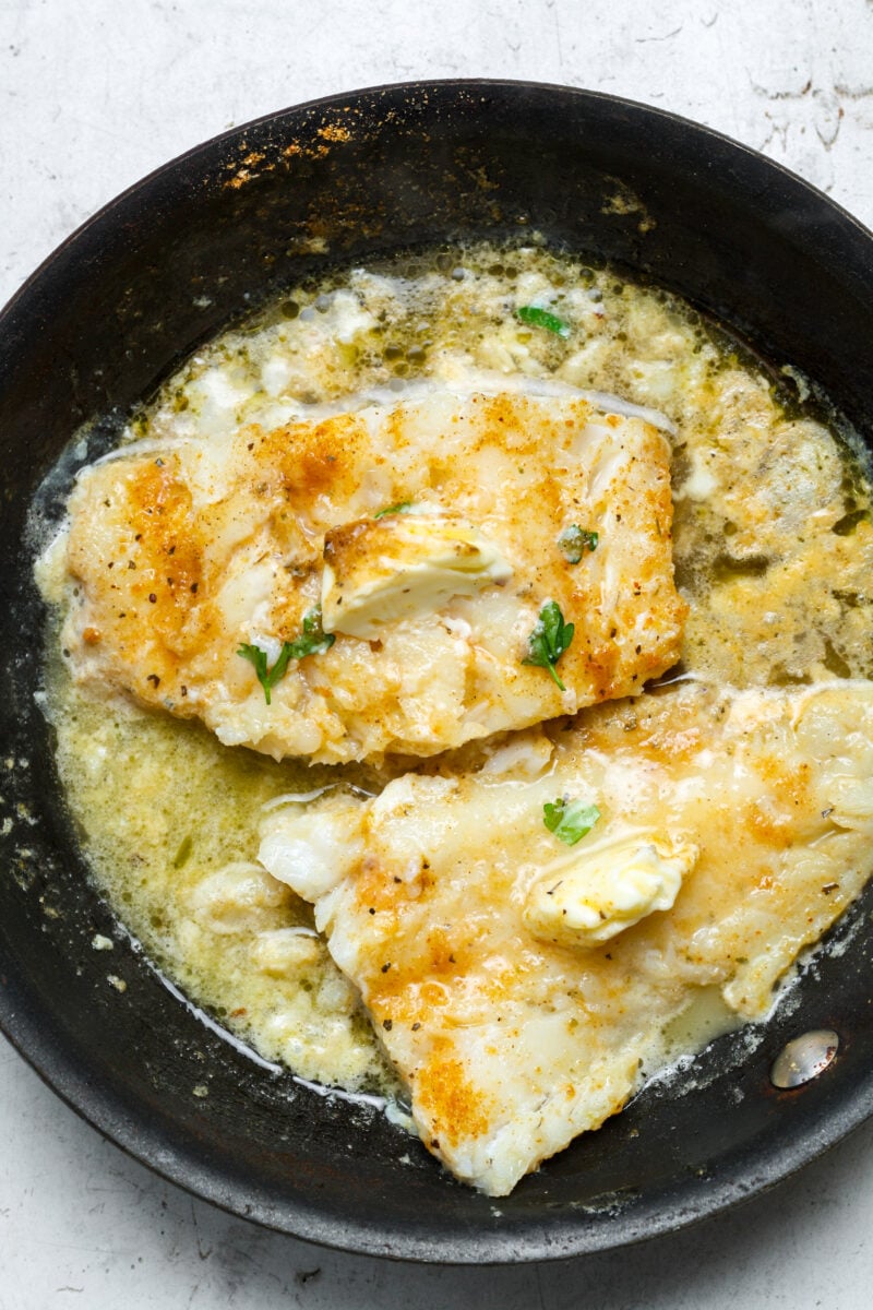 Buttery halibut in skillet.